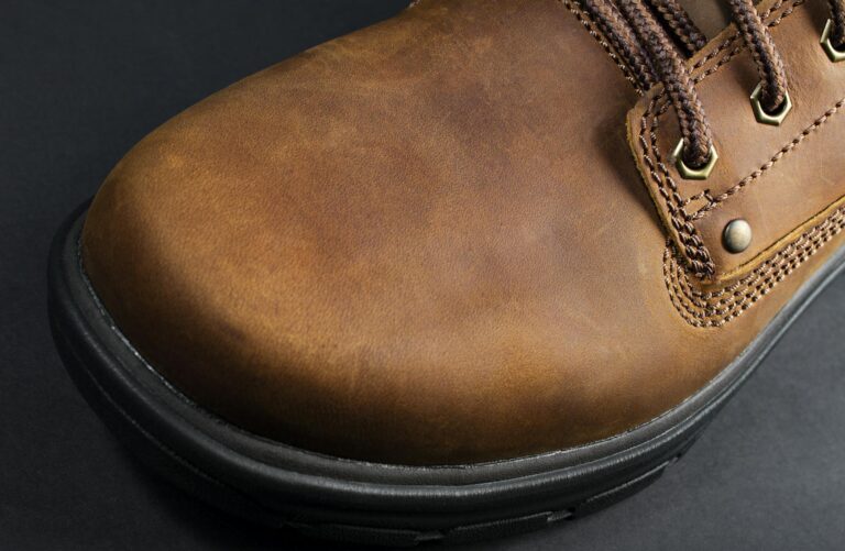 Detailed close-up shot of a brown leather boot showcasing texture and craftsmanship.